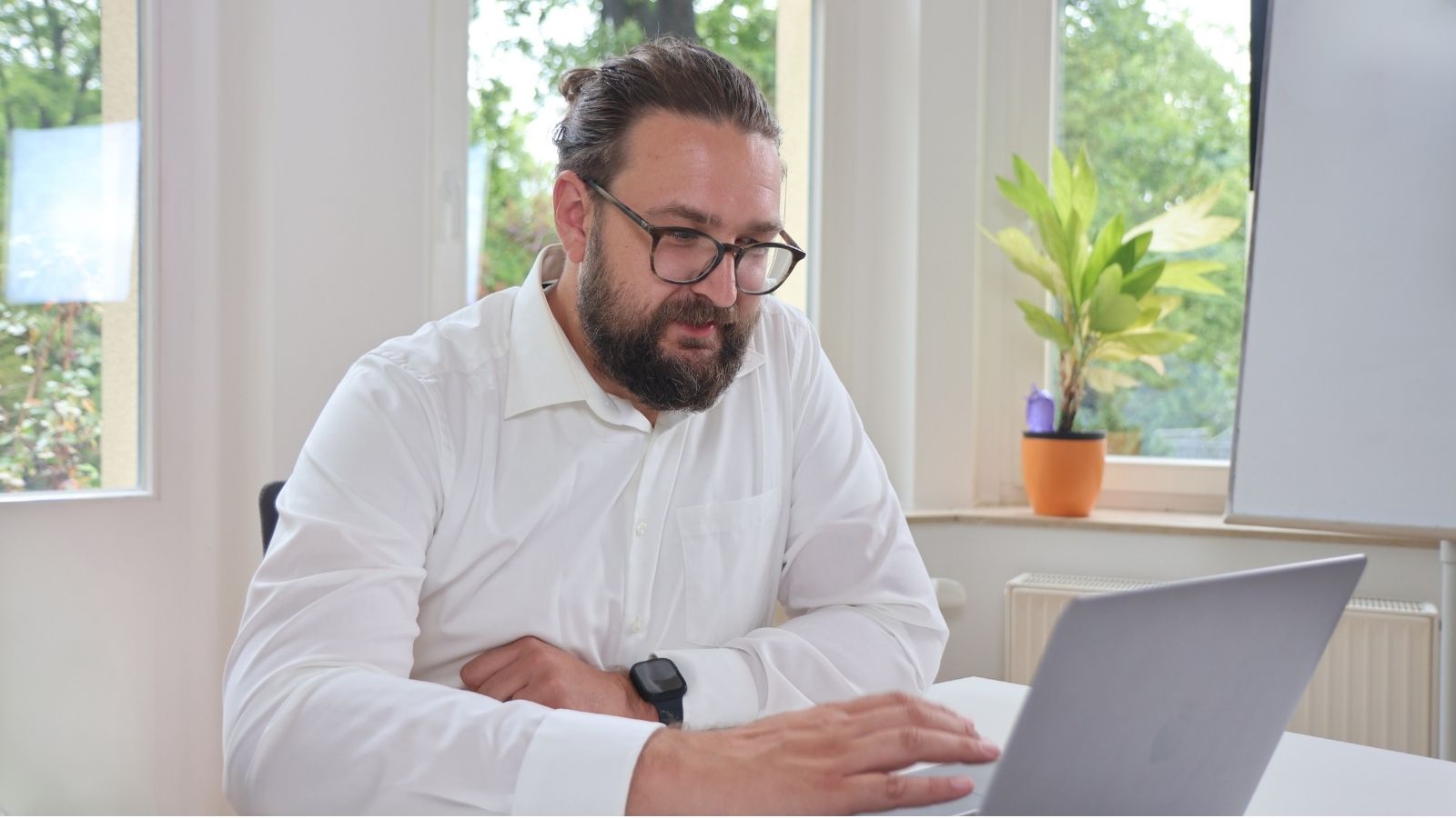 Christoph Schulz im Büro bei der Bearbeitung eines AVGS (Aktivierungs- und Vermittlungsgutschein)